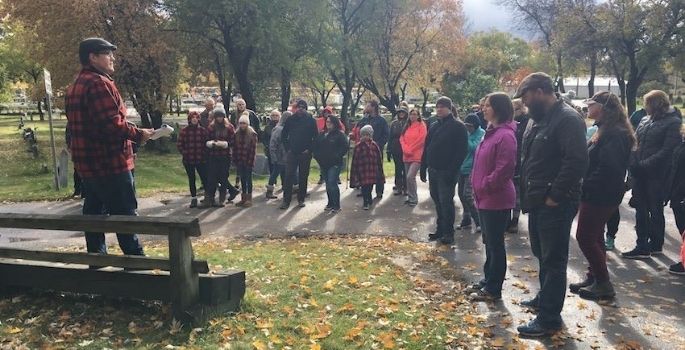 adults and children gathered for a tour of cemetery